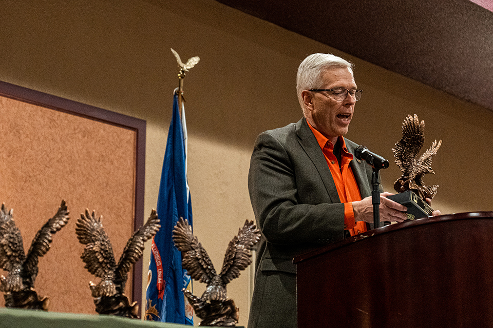 Erik Schnelle, Michigan state chair for the National Deer Association, accepts the Past Presidents Award at the 2023 MUCC Annual Convention Awards Banquet.