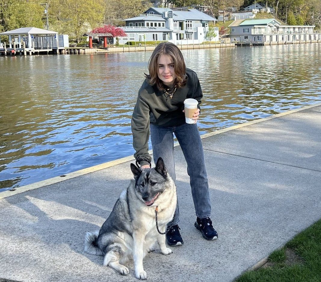 The author and her dog are standing on the pier of Wick's Park in downtown Saugatuck, Michigan; where the author lives.