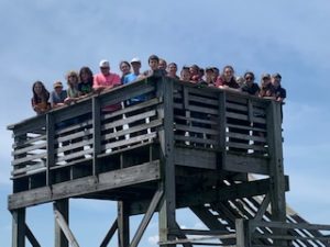 Students look out of the observation tower at Fish Point State Wildlife Area